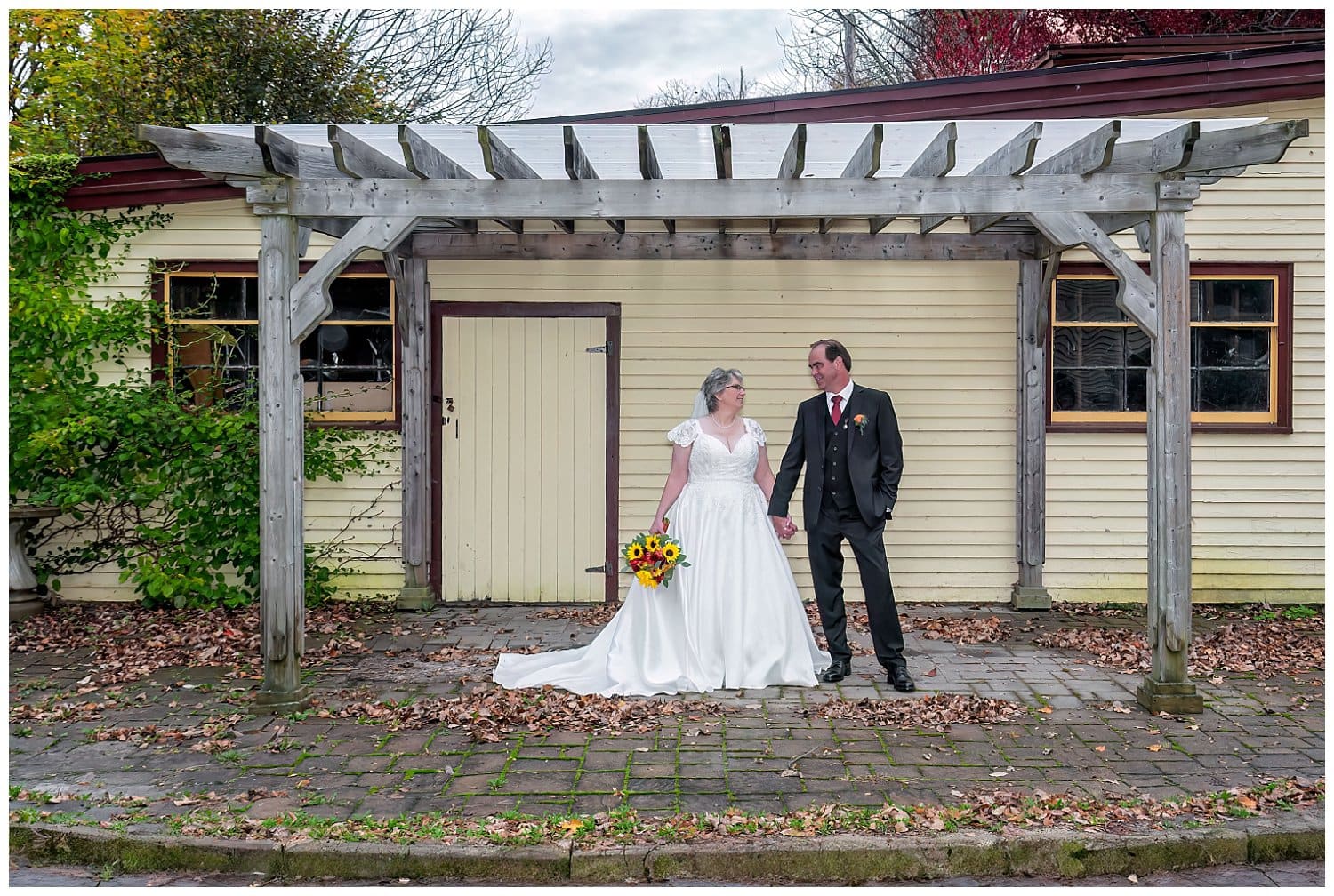 The bride and groom pose for wedding photos at a Victorian House in Windsor NS.
