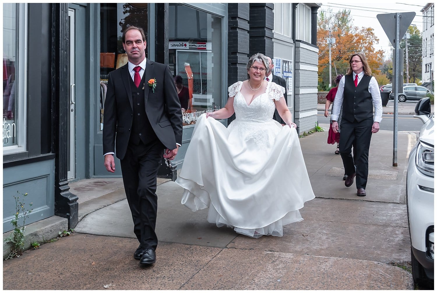 The bride and groom walk downtown Windsor NS after their wedding ceremony.