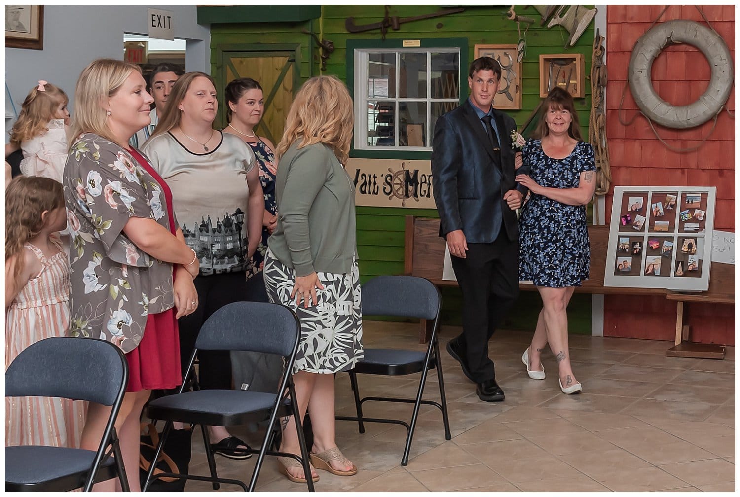 The groom walks his mother up the aisle during his wedding ceremony at Fishermans Cove's Heritage Center in Eastern Passage NS.
