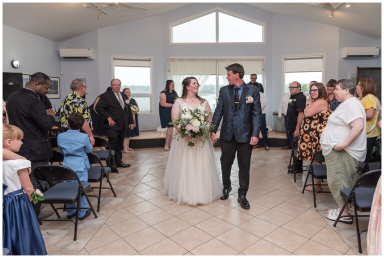 The bride and groom walk back down the aisle as husband and wife during their wedding ceremony.