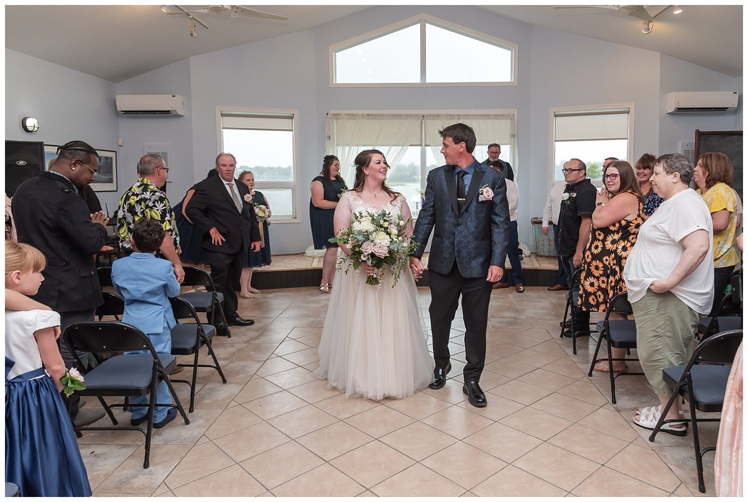 The bride and groom walk back down the aisle as husband and wife during their wedding ceremony.