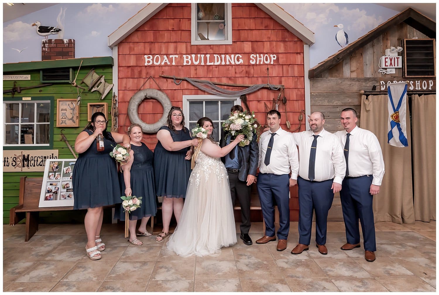The wedding party having fun with the bride and groom during wedding photos at Fishermans Cove in NS.