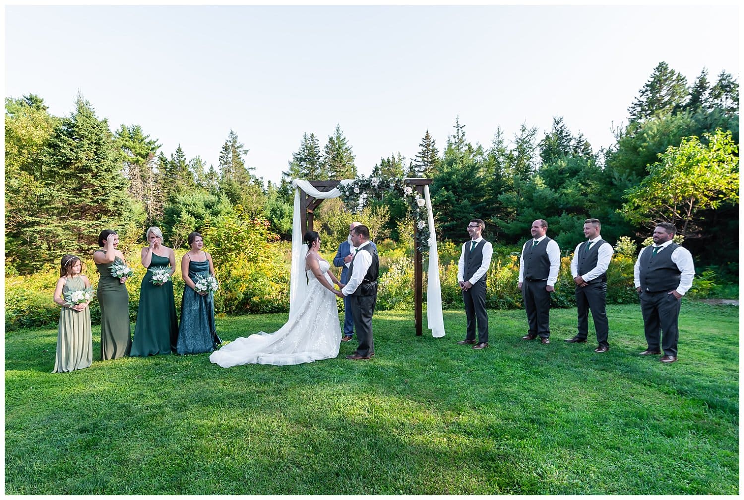 The wedding party stand with the bride and groom during their wedding ceremony at Hubbards Barn in NS.