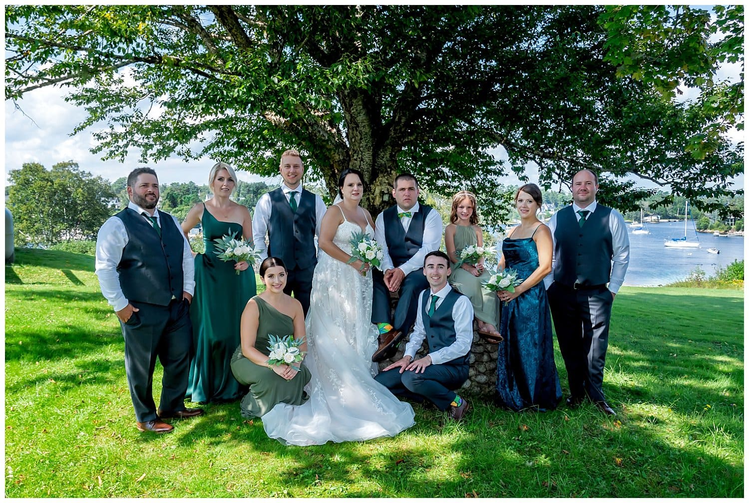The wedding party with the bride and groom pose for wedding photos in Hubbards Barn NS.