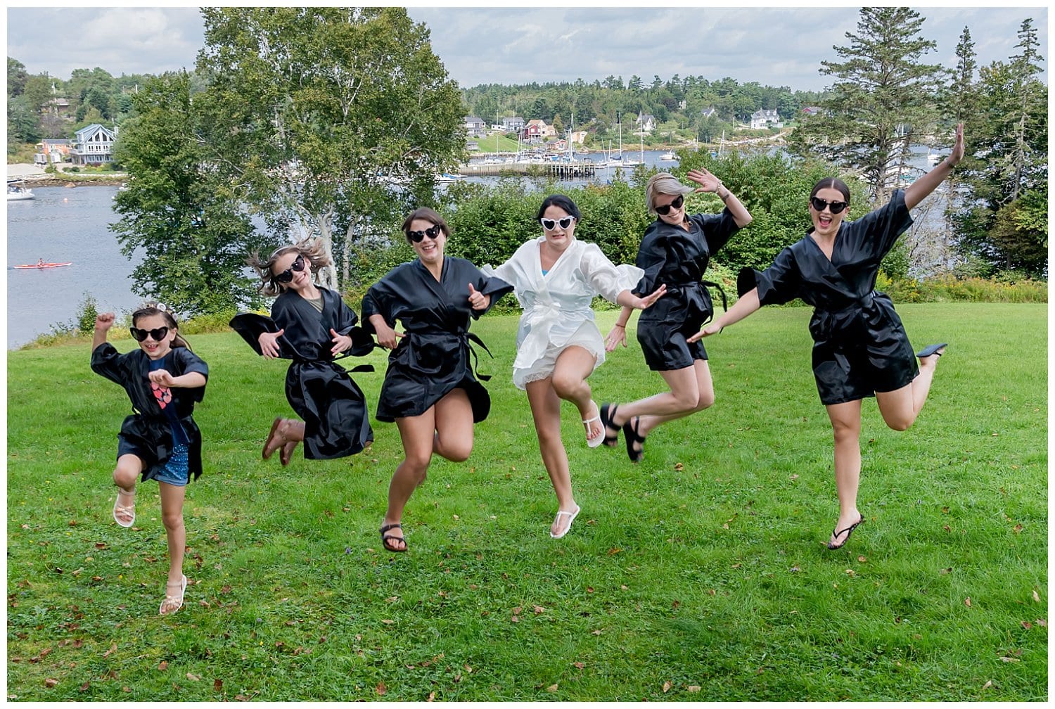 The bride and her bridesmaids have fun during wedding photos while getting ready for the big day.