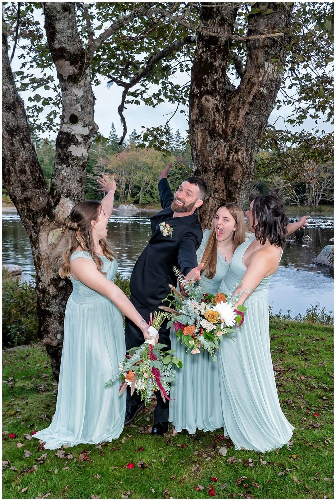 The groom and bridesmaids pose for fun wedding photos at Liscombe Lodge in NS.