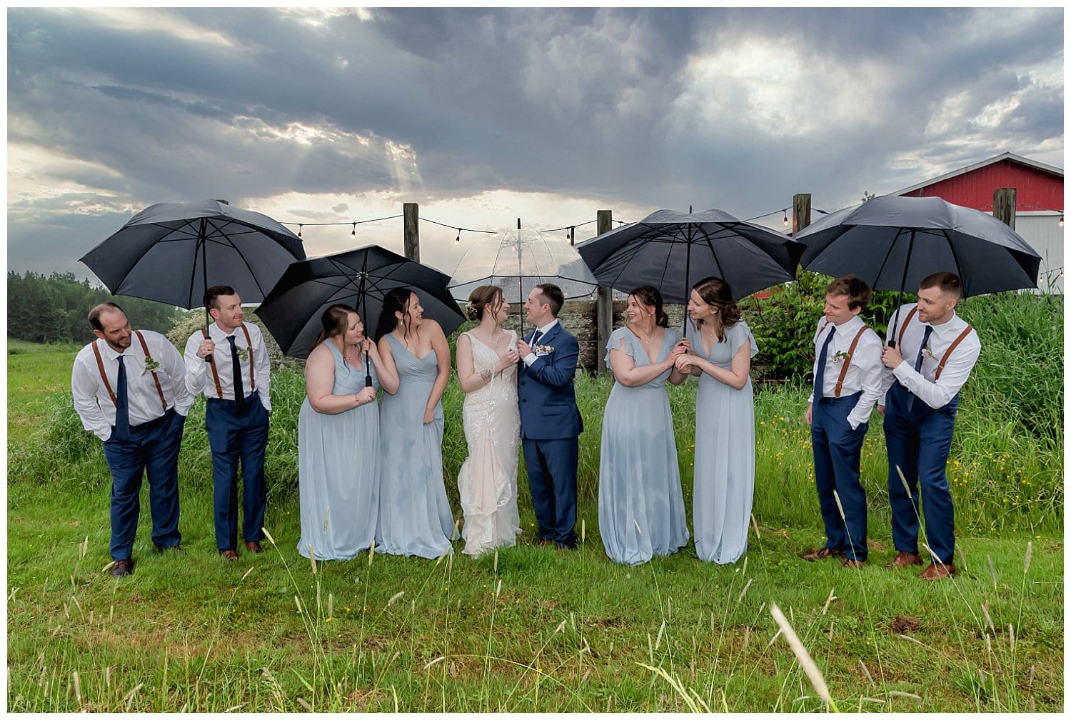 The wedding party pose for fun wedding photos with the bride and groom at Parker's Barn in Hopewell NS.