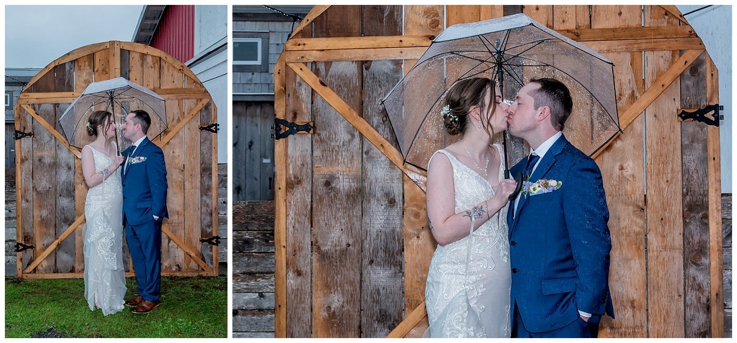The bride and groom pose for wedding photos in the rain at Parker's Barn in Hopewell NS.