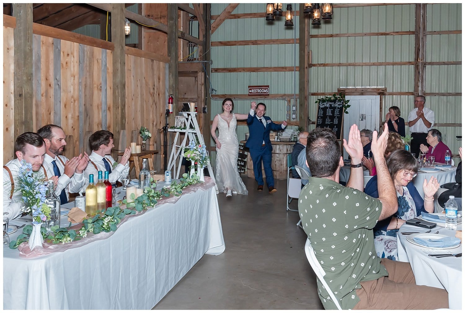 The bride and groom walk into Parkers Barn for their wedding reception in Hopewell NS.