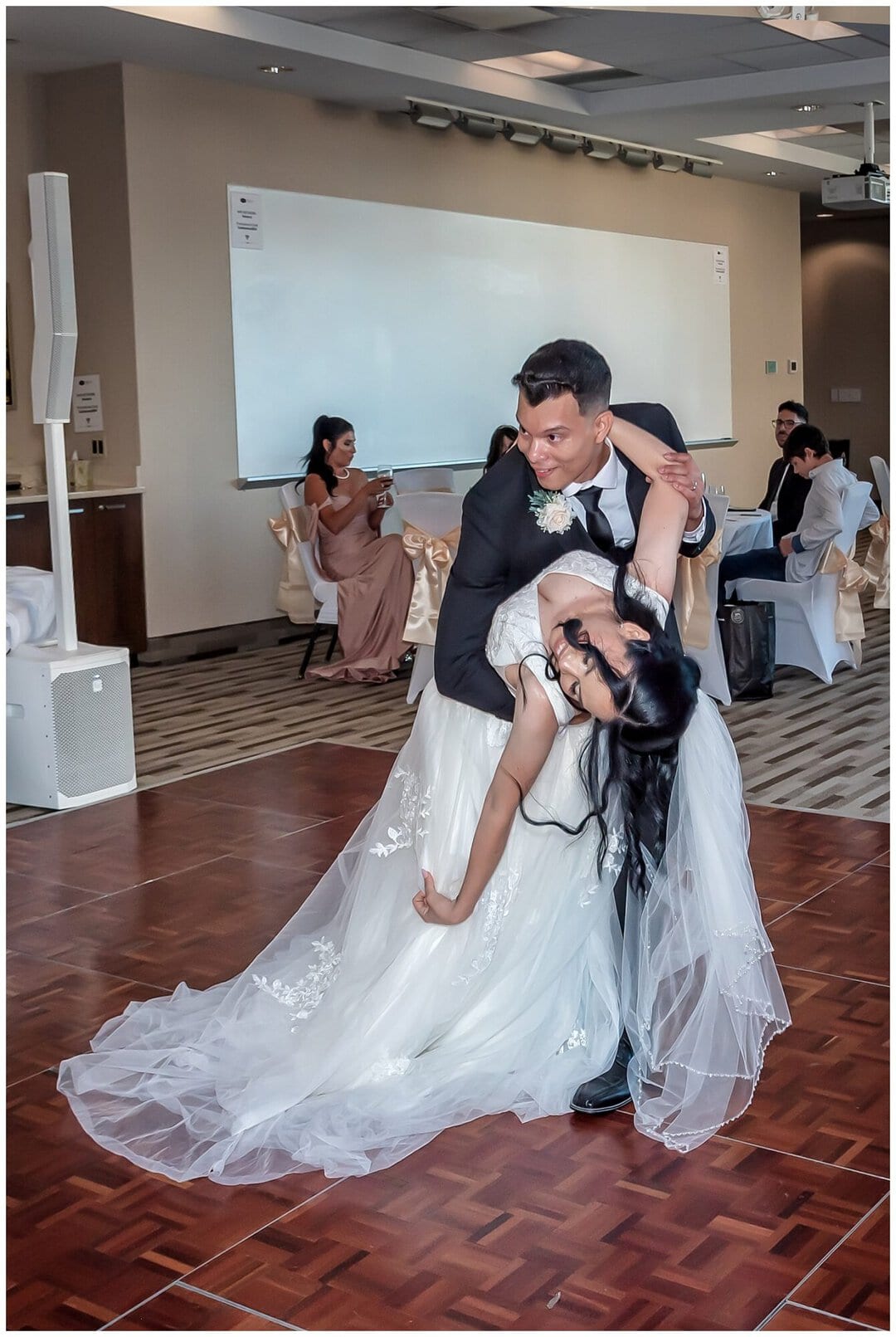 The groom dips the bride at the end of their first dance during their wedding reception at the Halifax Hampton Inn.