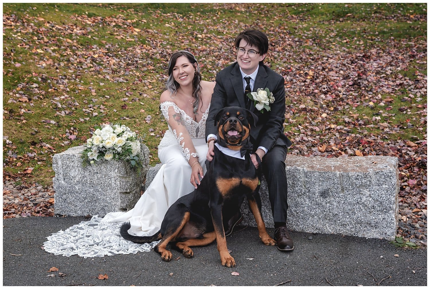 The bride and bride pose with their dog for wedding photos in Sir Fleming Park Halifax NS.