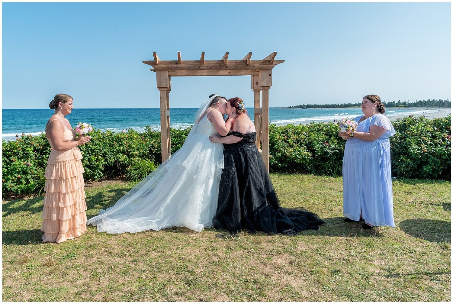 Both brides share their first kiss during their LGBT wedding ceremony at White Point Beach Resort in NS.