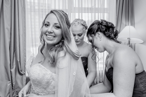 A bride with bridesmaids getting ready during bridal prep for a Juno Tower wedding.