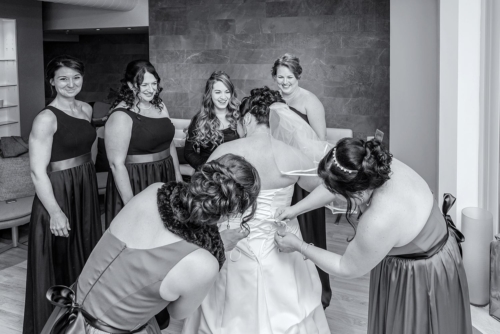 The bride with bridesmaids getting into her wedding dress at the Urban Spirit Spas in Halifax, NS.