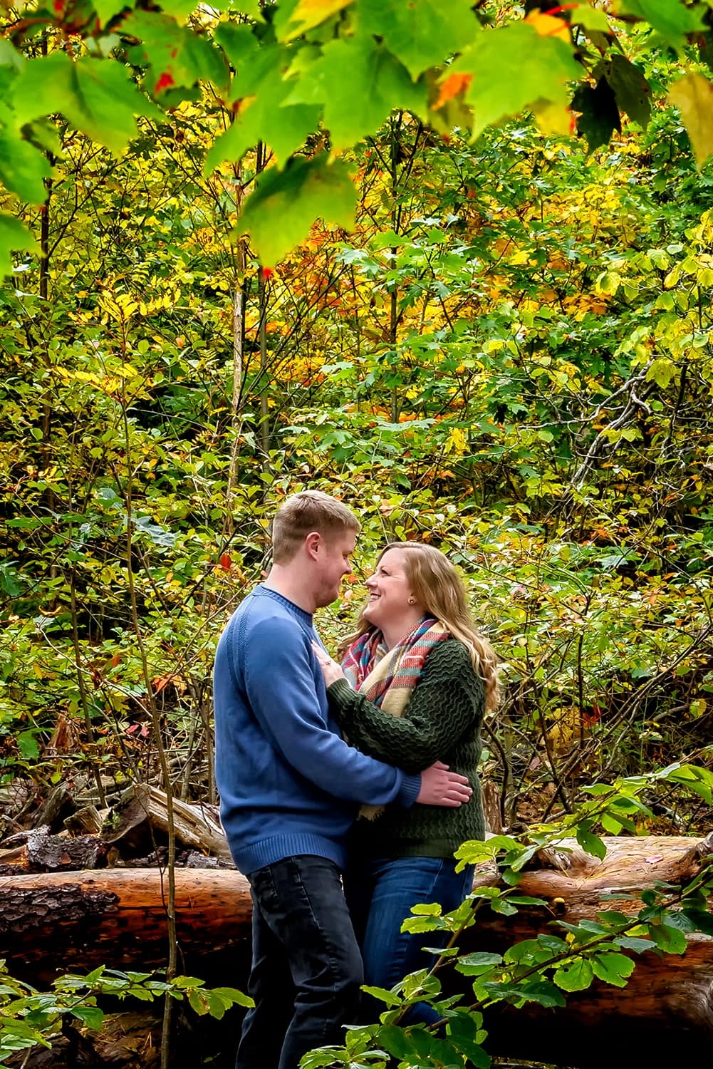 A couple in an embrace during their autumn engagement session at Point Pleasant Park in Halifax, NS.