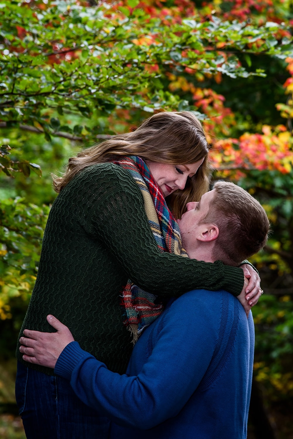 A man hugging his future wide during their engagement photos at Point Pleasant Park in Halifax, NS.