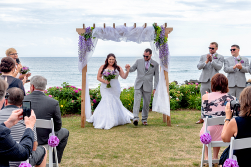A bride and groom walk down the aisle after their wedding ceremony at White Point in NS.