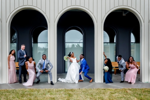 The bride and groom create fun poses during their wedding photos at the Cedar Events Center in Halifax NS with Halifax wedding photographers.