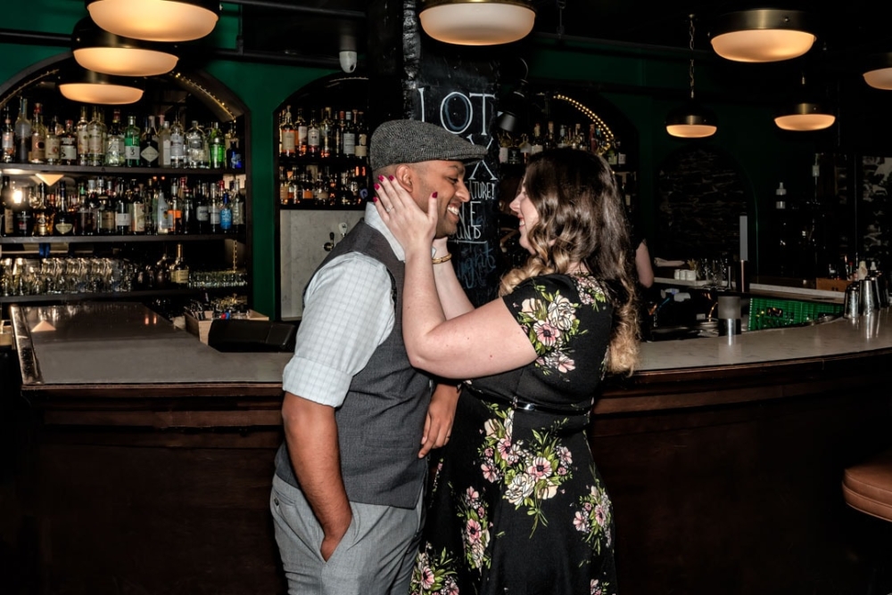 A newly engaged couple embracing during their engagement photos at Lot 6 in Halifax, NS.