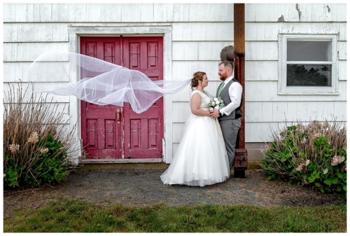 The bride and groom pose for wedding photos at Healy Farm in Kentville NS.