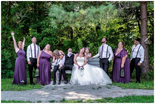 The wedding party pose exhausted in 41 degree weather at First Park in Sackville NS,