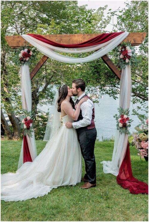 The bride and groom have their first kiss as husband and wife during their wedding ceremony at Saraguay House in Halifax NS.